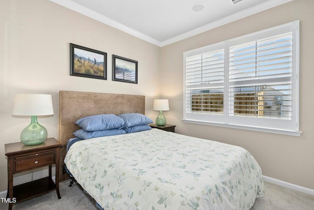 carpeted bedroom with crown molding and baseboards