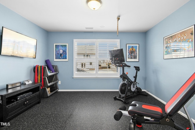 exercise area featuring visible vents and baseboards