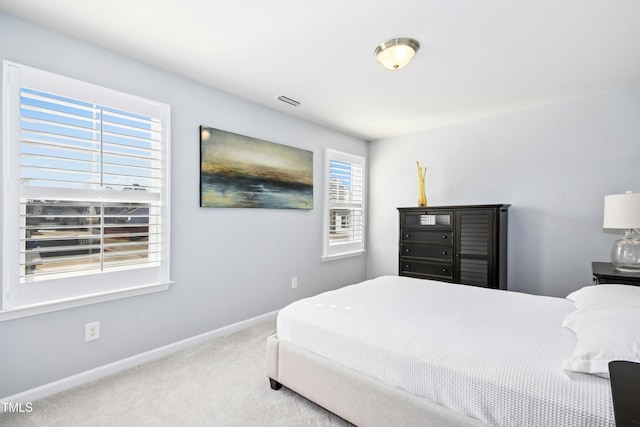 bedroom featuring visible vents, baseboards, and carpet