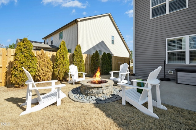 view of patio with an outdoor fire pit and fence