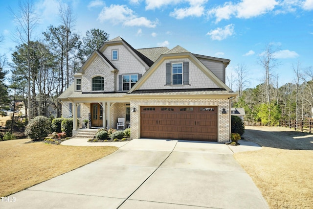 view of front of house featuring a front lawn, covered porch, concrete driveway, an attached garage, and brick siding