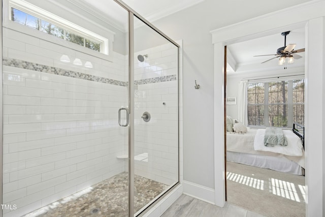 ensuite bathroom with a stall shower, connected bathroom, plenty of natural light, and ornamental molding