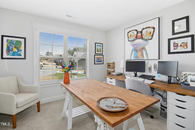 office with baseboards, visible vents, and light carpet