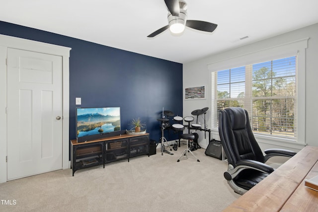 carpeted home office with visible vents and ceiling fan