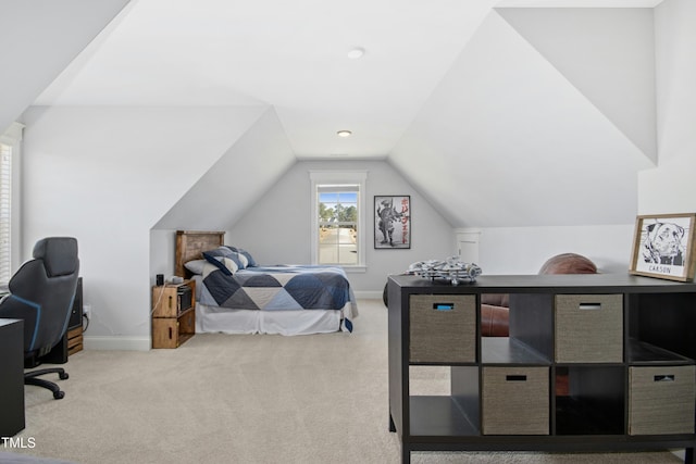 bedroom featuring baseboards, lofted ceiling, and carpet