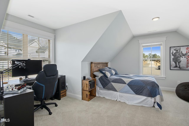 bedroom with lofted ceiling, baseboards, visible vents, and light carpet