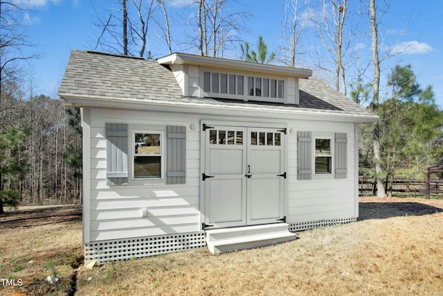 view of shed with fence