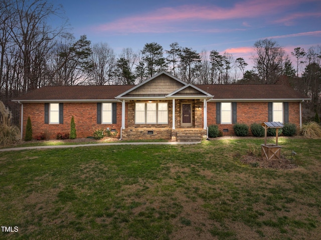 ranch-style house with crawl space, brick siding, and a front yard