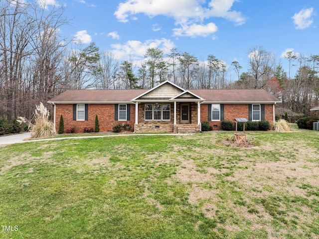 ranch-style home featuring crawl space, brick siding, and a front yard