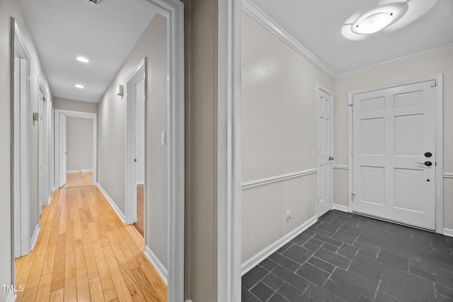 hall featuring baseboards and crown molding