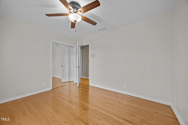 empty room with light wood-style flooring, baseboards, and visible vents