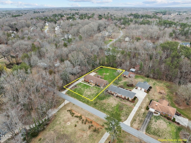 birds eye view of property featuring a forest view