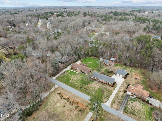 birds eye view of property with a wooded view