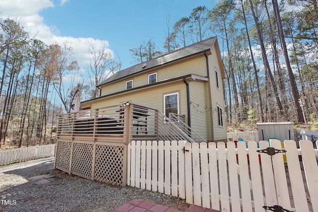 back of house with a wooden deck and fence