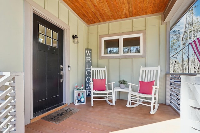 entrance to property with a porch and board and batten siding