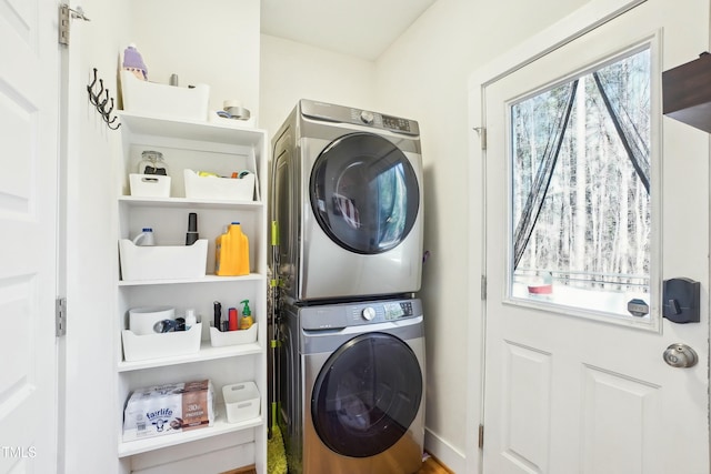 laundry area with laundry area and stacked washer / dryer