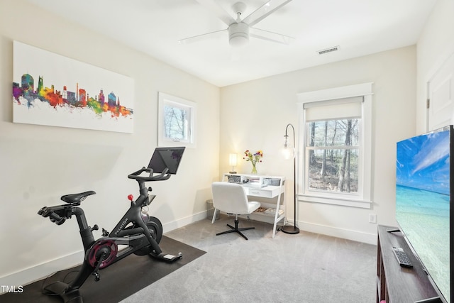 exercise area featuring visible vents, baseboards, a ceiling fan, and carpet flooring