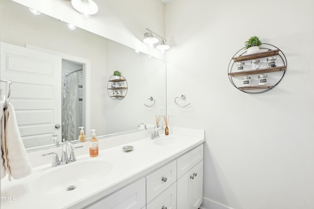 full bathroom featuring double vanity, baseboards, and a sink