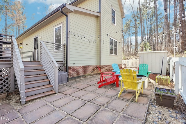 view of patio featuring stairs and fence