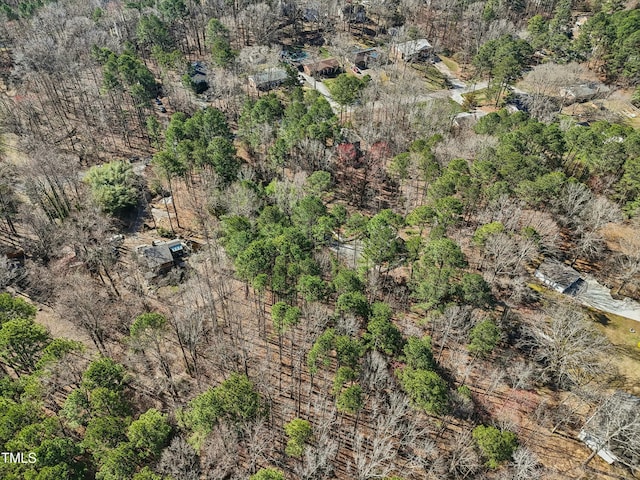 birds eye view of property with a view of trees