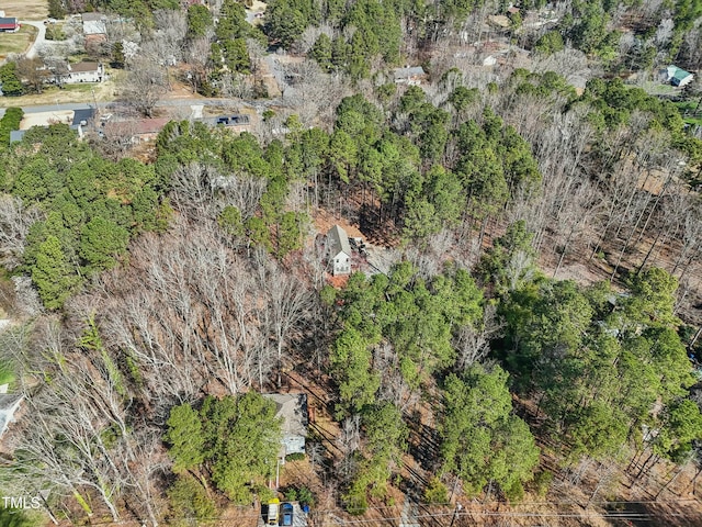 drone / aerial view featuring a wooded view