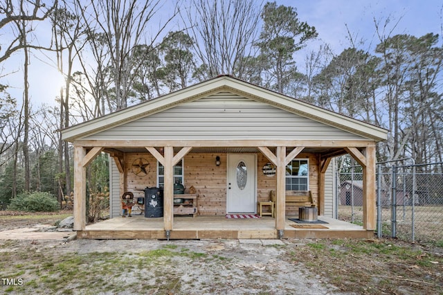 view of front of property with a gate, covered porch, and fence