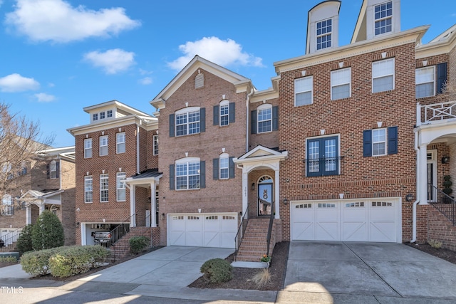 view of front of house featuring brick siding, driveway, and a garage