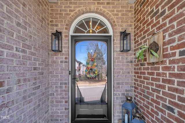 entrance to property with brick siding