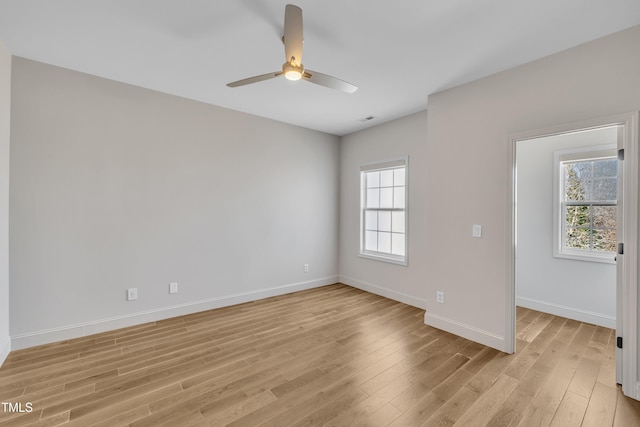 unfurnished room featuring visible vents, baseboards, light wood finished floors, and ceiling fan