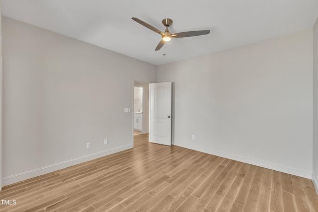 unfurnished room with a ceiling fan, light wood-type flooring, and baseboards