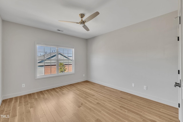 unfurnished room with ceiling fan, baseboards, visible vents, and light wood-type flooring