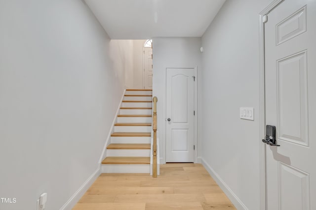 stairway featuring wood finished floors and baseboards