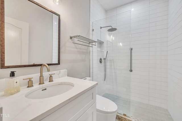 full bath with vanity, toilet, and tiled shower