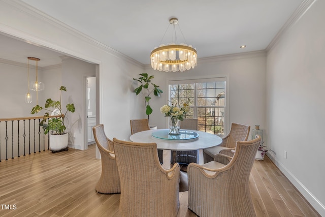 dining area featuring a notable chandelier, ornamental molding, baseboards, and wood finished floors