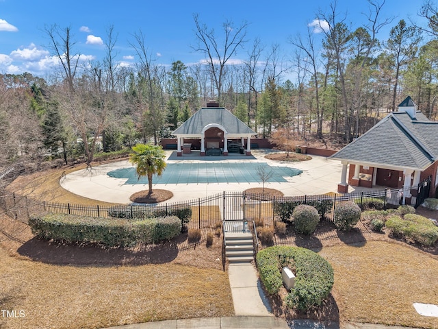 community pool with a gazebo, a patio area, and fence