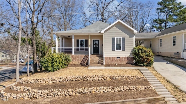 view of front facade featuring crawl space, a porch, and concrete driveway