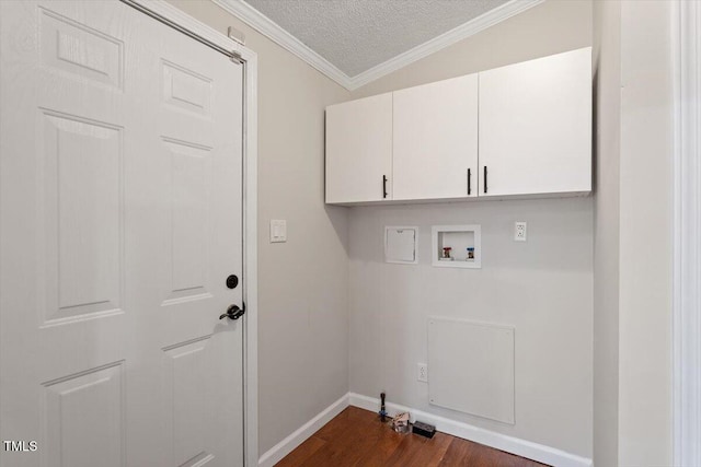 laundry room featuring washer hookup, a textured ceiling, dark wood-style floors, cabinet space, and crown molding