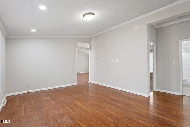 unfurnished room with crown molding, baseboards, and wood finished floors