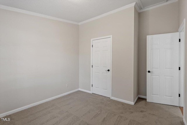 unfurnished bedroom featuring baseboards, carpet, and crown molding