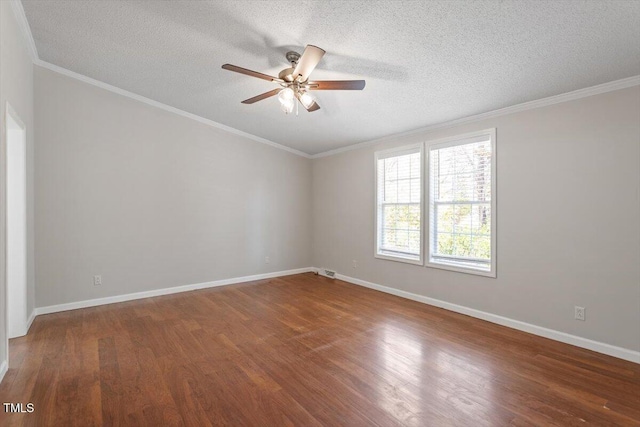 unfurnished room featuring baseboards, wood finished floors, and ornamental molding