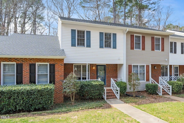 townhome / multi-family property with brick siding