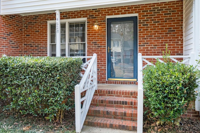 property entrance featuring brick siding