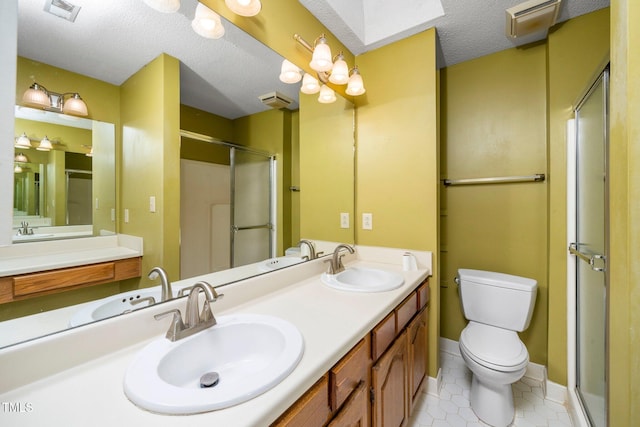 bathroom with a sink, visible vents, toilet, and a stall shower