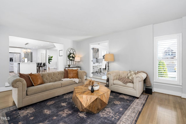 living area with wood finished floors and baseboards