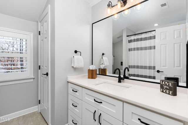 bathroom featuring vanity, baseboards, visible vents, and tile patterned flooring