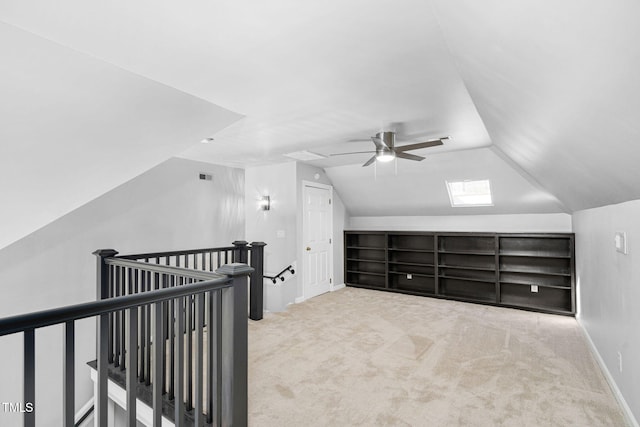 additional living space featuring visible vents, ceiling fan, baseboards, carpet, and vaulted ceiling