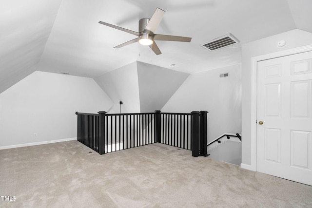 additional living space with visible vents, carpet, a ceiling fan, and vaulted ceiling