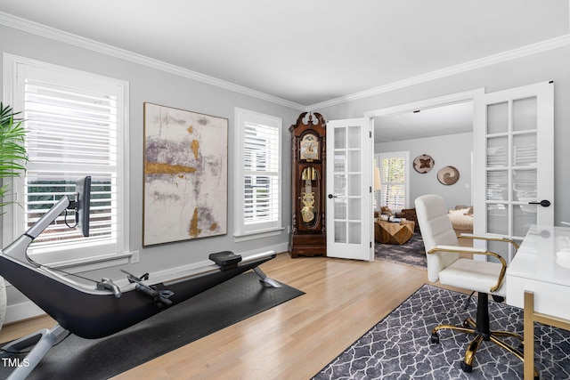 office featuring french doors, crown molding, and wood finished floors