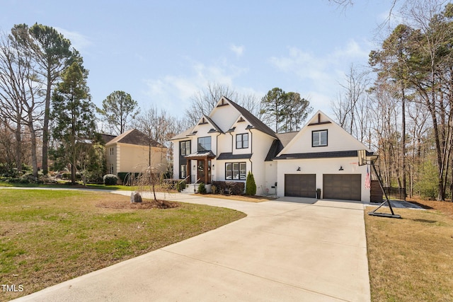 modern farmhouse featuring a garage, concrete driveway, and a front lawn