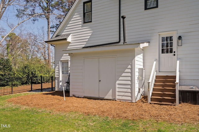 doorway to property featuring fence